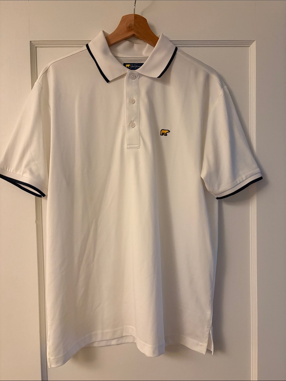 White Polo Shirt with Navy Trim and Small Yellow Logo